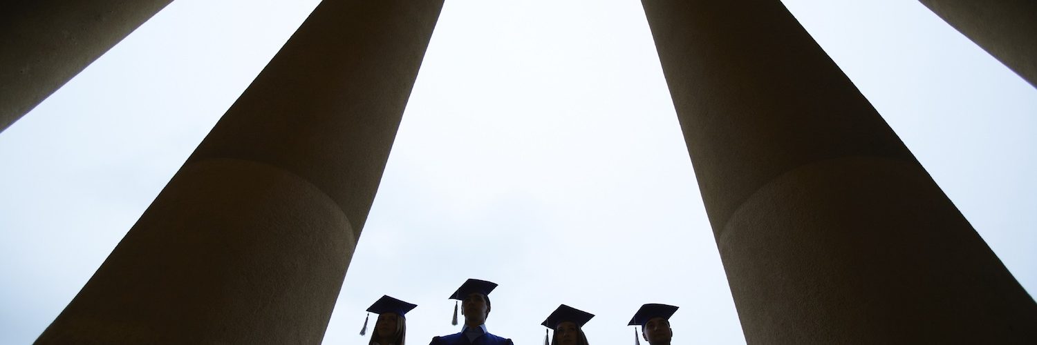 Outlines of four graduates between columns of university building
